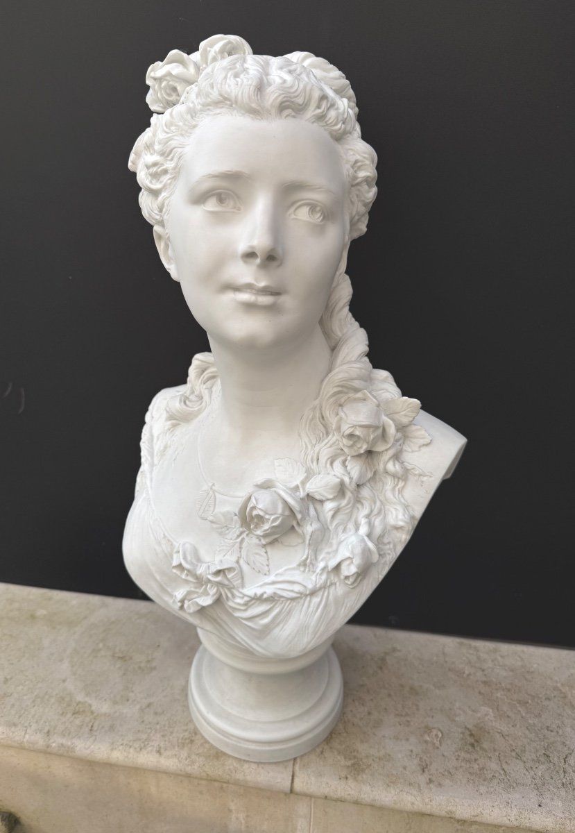 Buste de femme en bIscuit,
Ce buste présente  un riche décor de fleurs de roses dans la coiffure et sur le buste, nœud Louis XVl ,
Ce buste repose sur un piédouche.
signé à l'arrière :  A . Carrier,
Artiste Albert-Ernest Carrier de Belleuse dit Carrier-Belleuse, né à Anizy-le-Château le 12 juin 1824 et mort à Sèvres le 3 juin 1887, est un sculpteur français 
