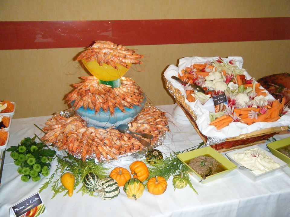 Buffet composé d'une tour de crevettes, d'un plateau de légumes, de petites courges et de sauces.