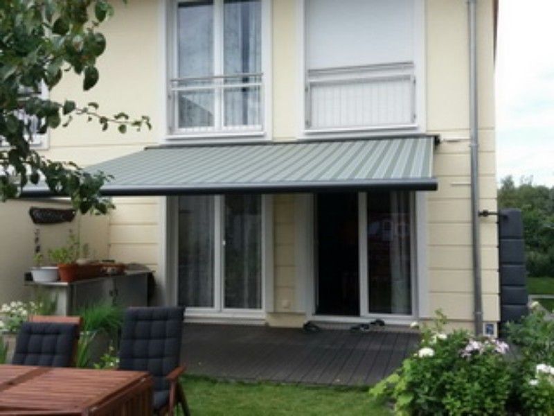 Ein Haus mit einem Tisch und Stühlen davor