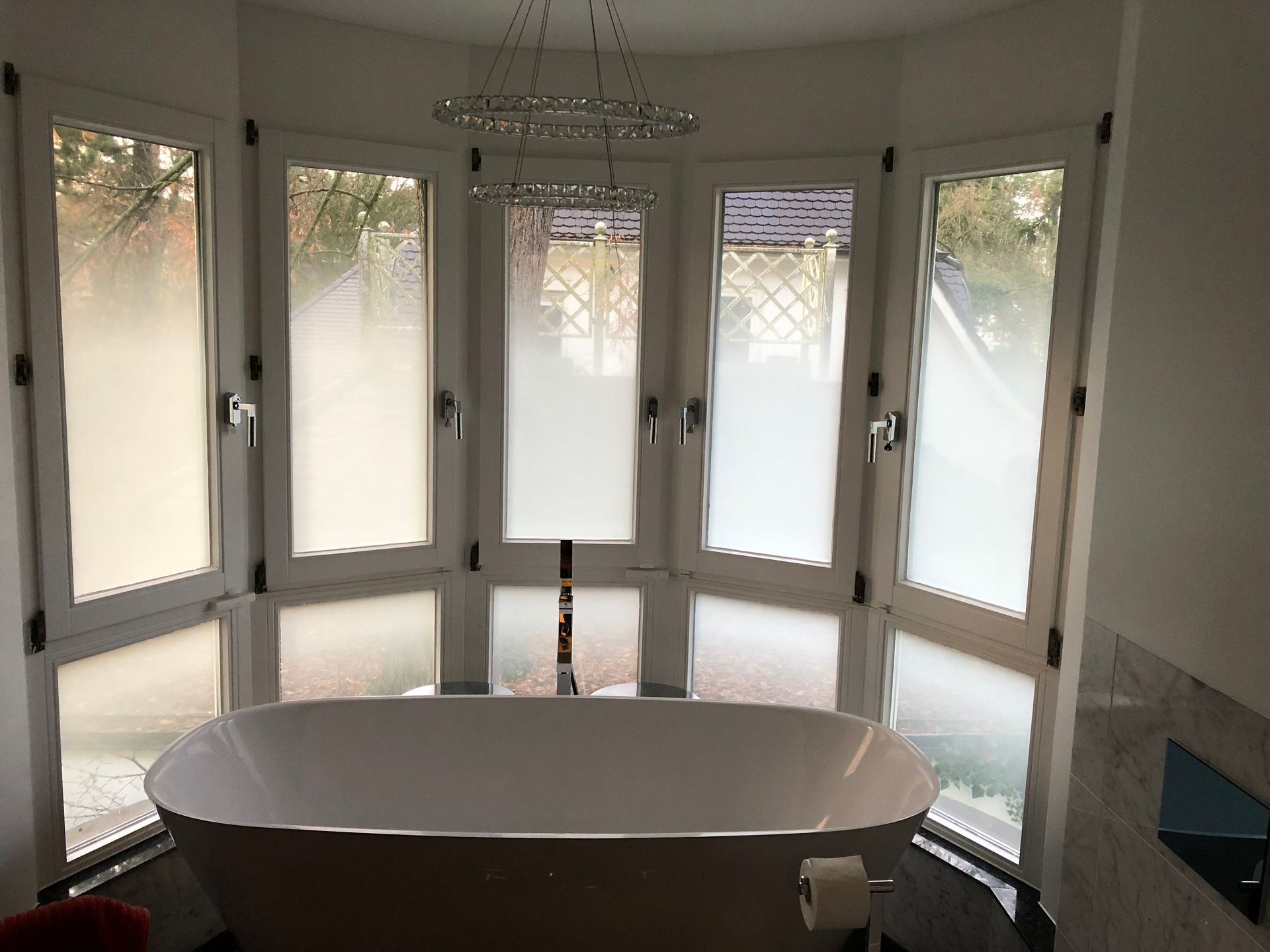 Eine Badewanne in einem Badezimmer mit vielen Fenstern