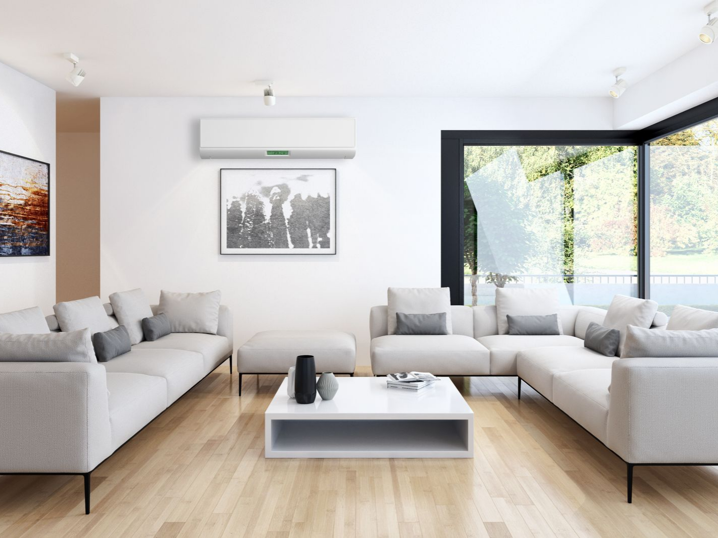 Salon moderne avec canapés, table basse et grandes fenêtres et un climatiseur mural.