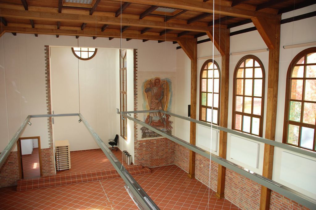 Ein Raum mit Bogenfenstern und einer Holzdecke