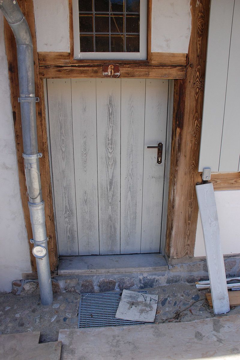 Eine weiße Holztür mit einem Fenster darüber