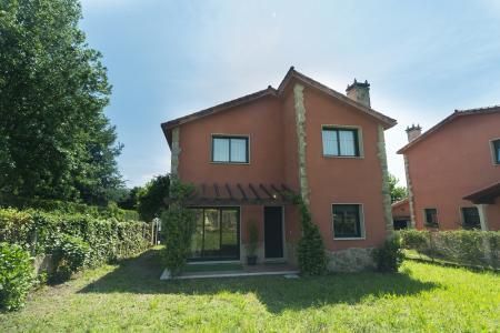 Campo de golf en un día nublado, con césped verde, árboles y un carrito de golf.