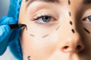 Un primer plano del rostro de una mujer con líneas dibujadas en él.