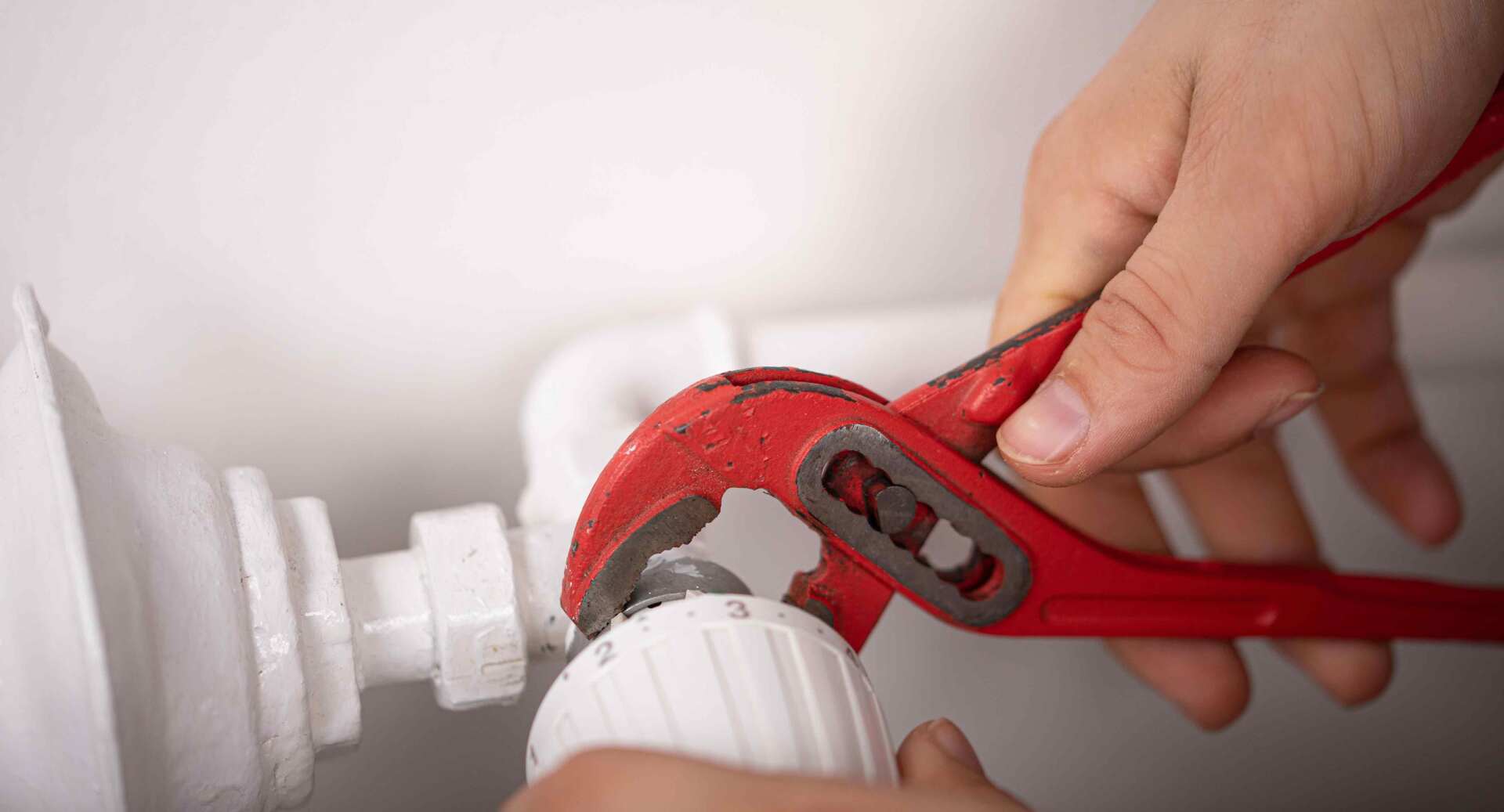 Un chauffagiste réglant un radiateur