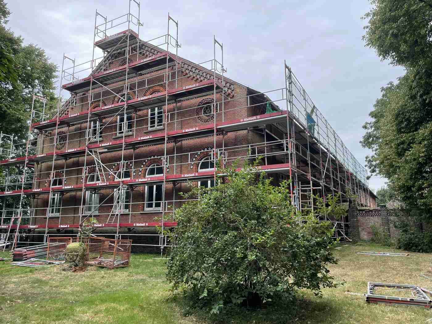 Es wird ein großes Gebäude errichtet, das von einem Gerüst umgeben ist.