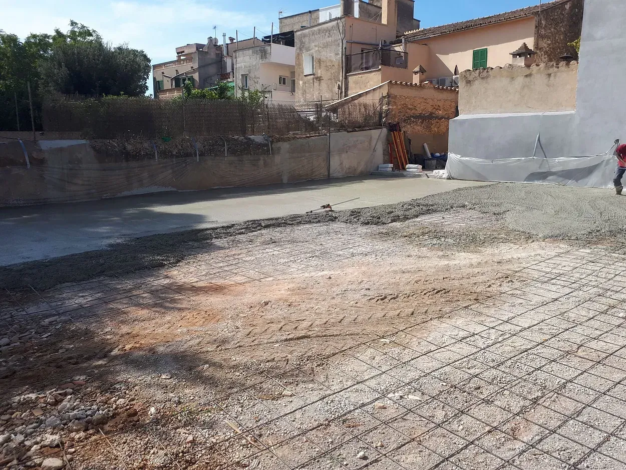 Se está construyendo un camino de entrada de hormigón frente a un edificio.