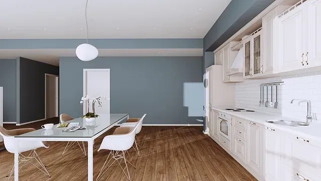 Una cocina con una mesa de comedor y sillas.