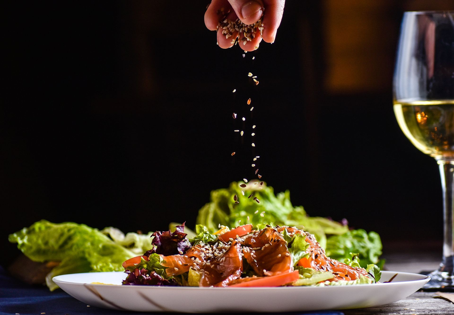 Fresh European salad with sesame topping and wine