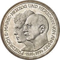 Eine Silbermünze mit einem Mann und einer Frau darauf.