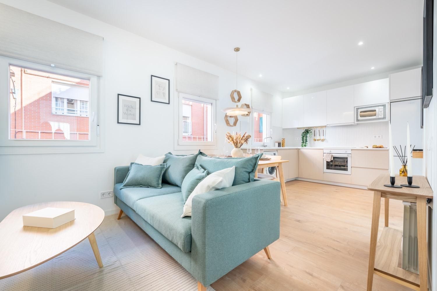 Una sala de estar con un sofá azul y una mesa de madera.