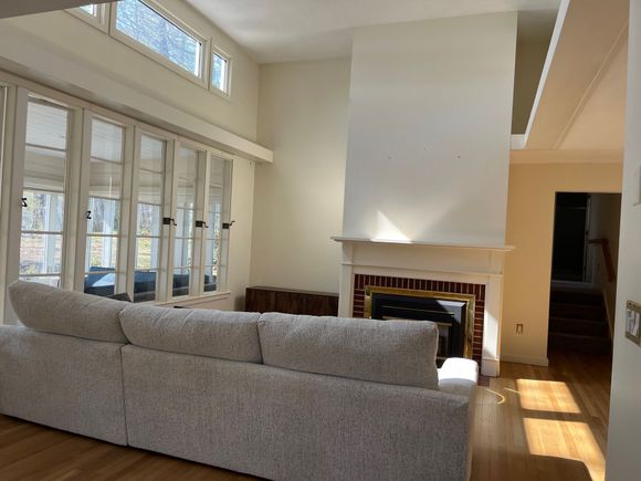 A living room with a fireplace and a couch