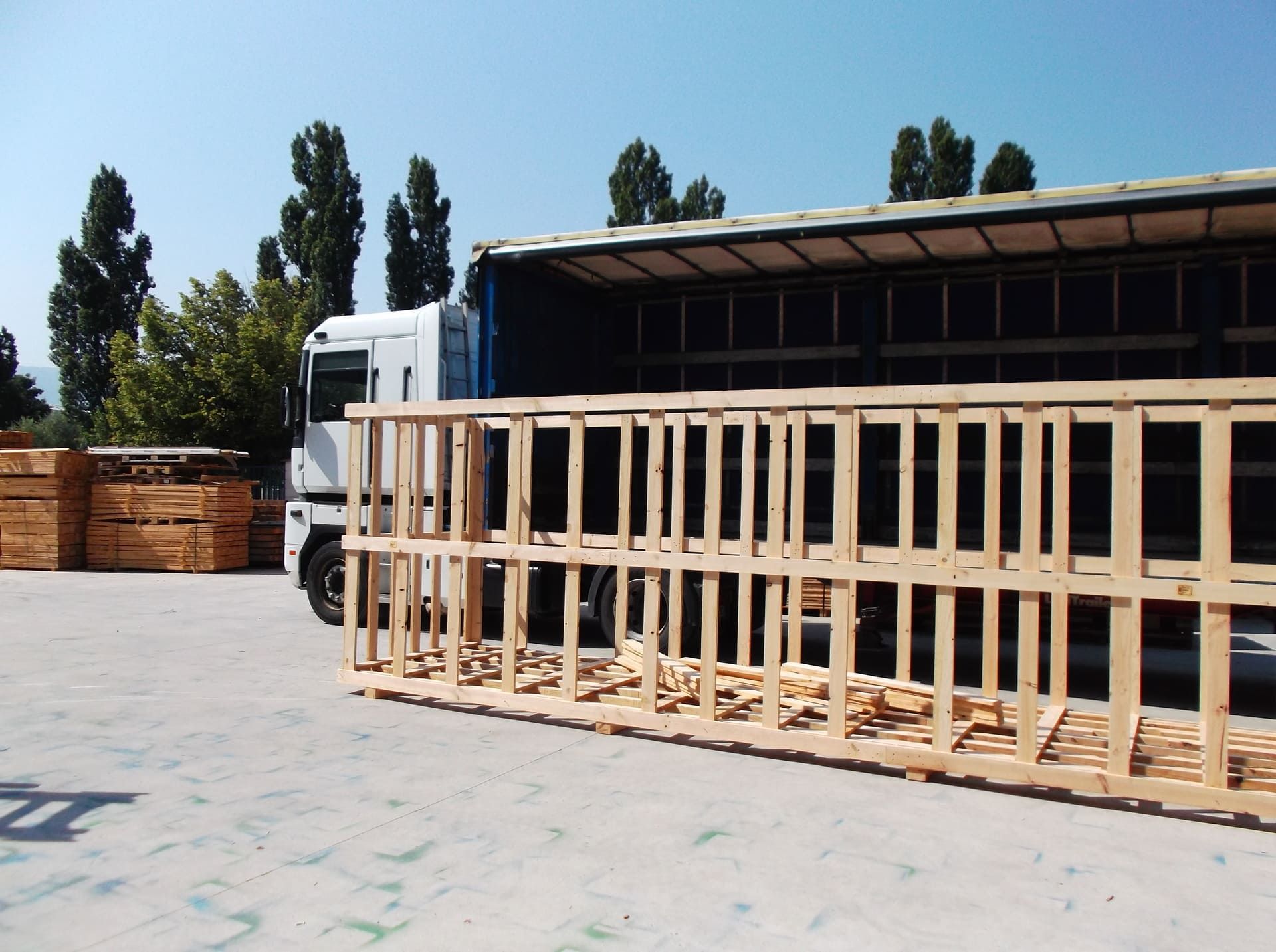 Un camión transporta cajas de madera en un estacionamiento.