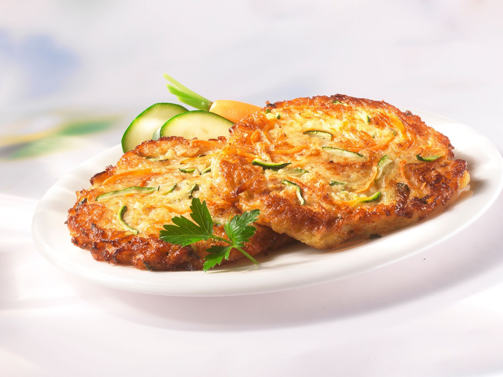 Ein weißer Teller mit zwei Puffern und Gemüse