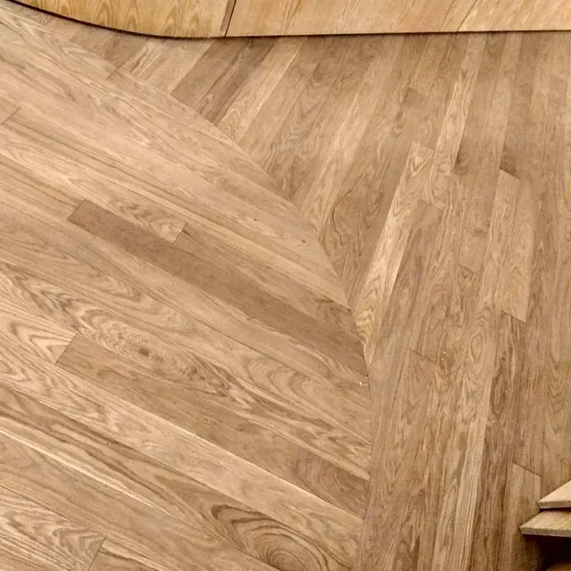 Un primer plano de un piso de madera con un patrón de chevron.