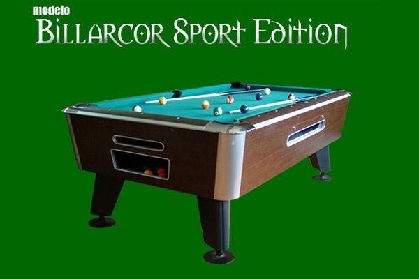 Una mesa de billar Billarcor Sport Edition con bolas sobre el fieltro verde, sobre un fondo verde.