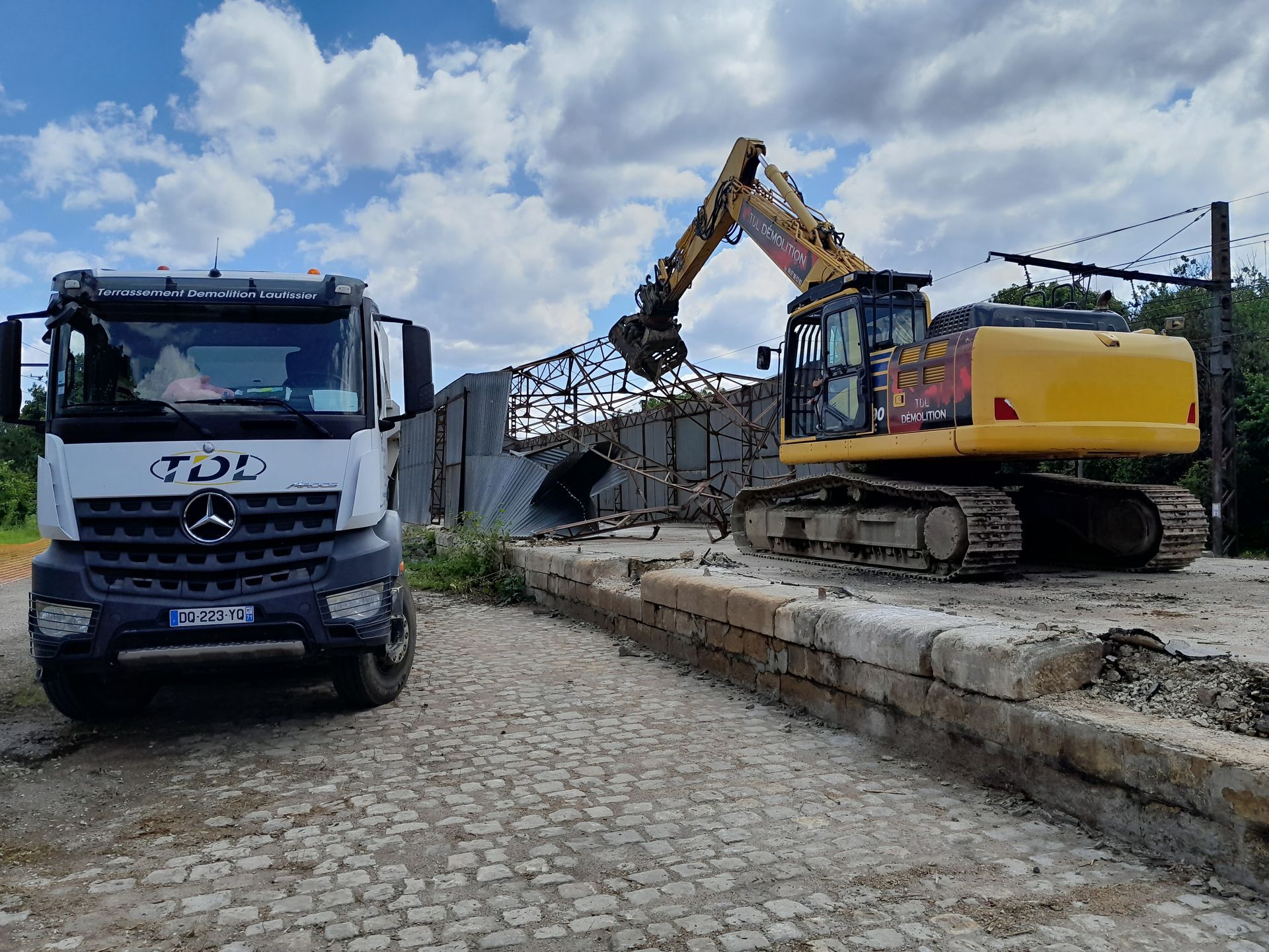 Camion et tractopelle pour une démolition efficace