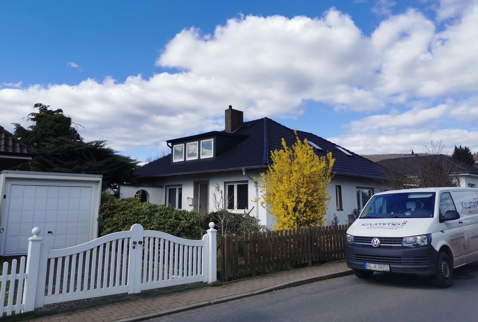 Ein weißer Lieferwagen steht vor einem Haus