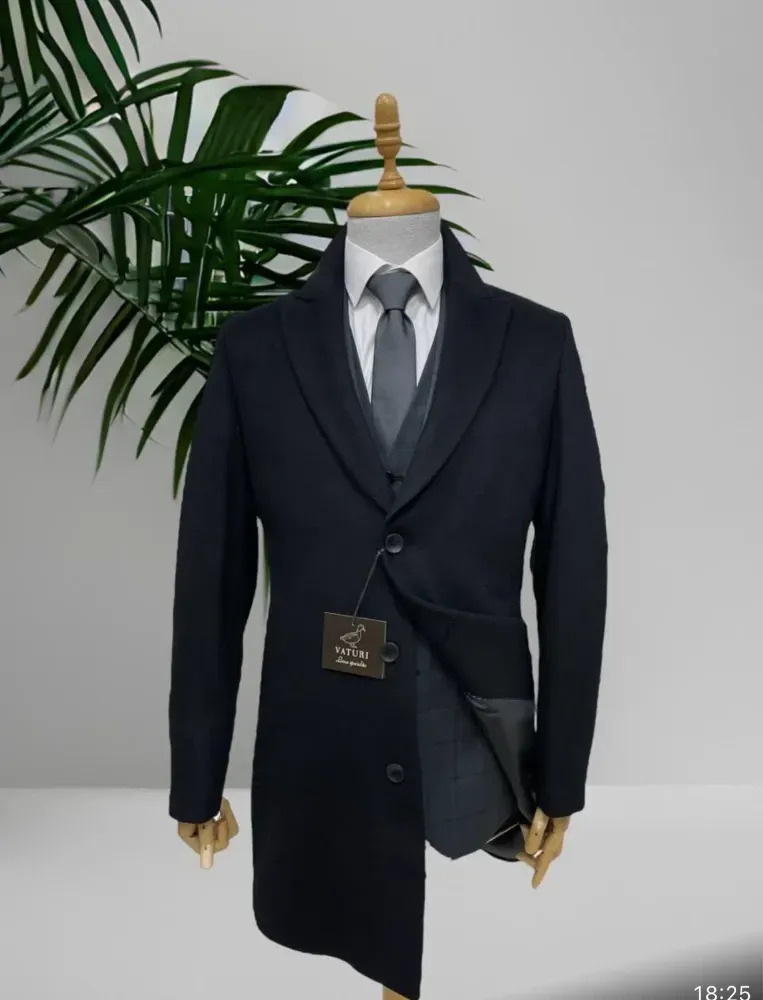 A wooden table topped with a blue shirt , tie , shoes , glasses , belt , watch and sunglasses.