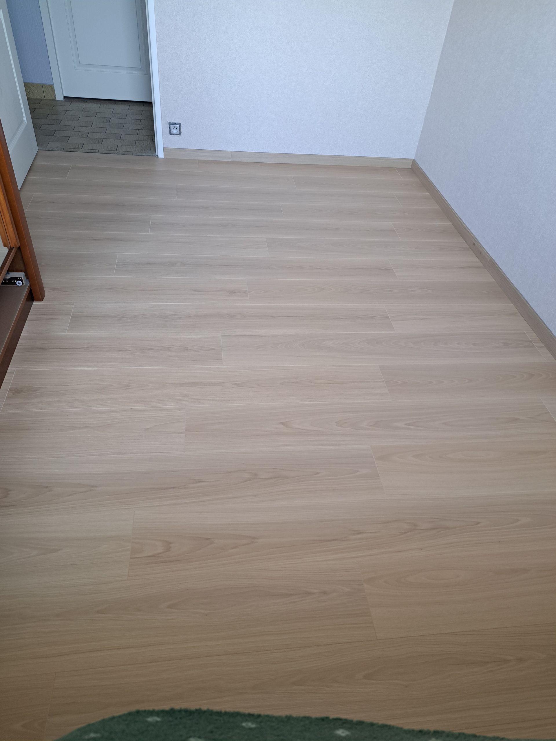 Artisan posant du parquet à l'aide d'un maillet