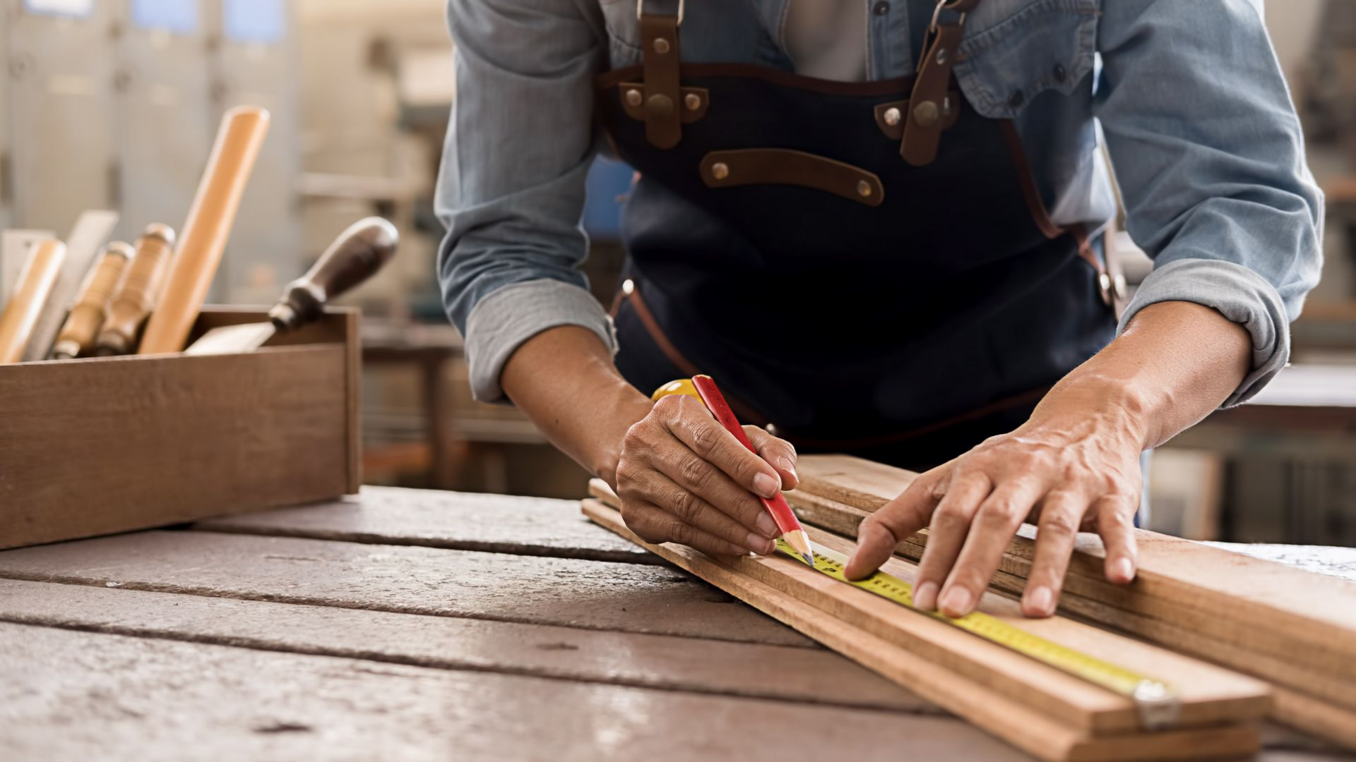 Artisan prenant des mesures sur une planche en bois