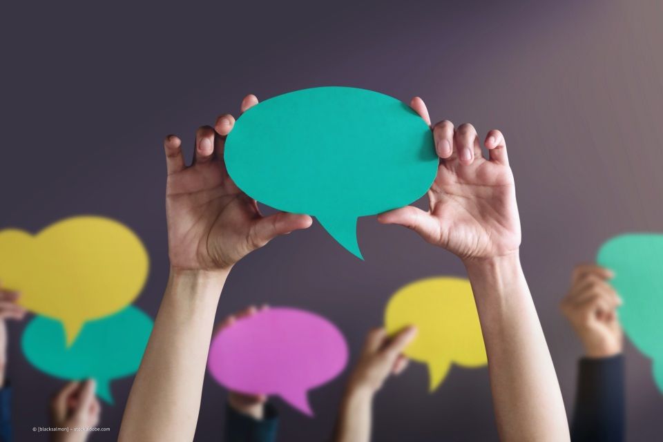 Hand hält eine grüne Sprechblase aus Papier, Logopädie im Ratzelbogen