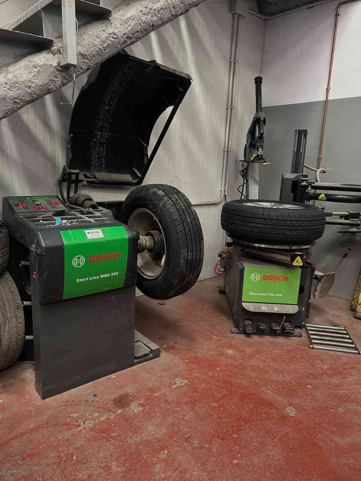 Motocicleta de trial Beta roja y negra sobre soporte negro, motor visible.