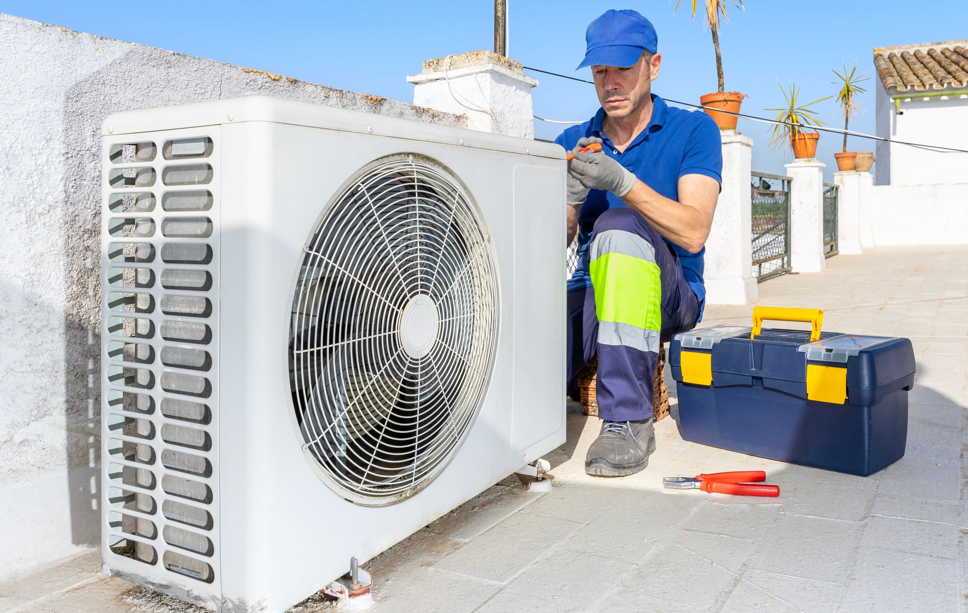 Un monsieur réalise l'entretien de la pompe à chaleur
