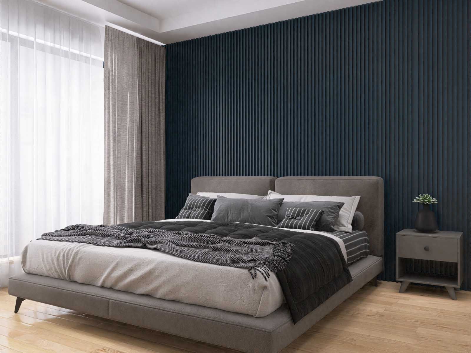 Un dormitorio con una cama, mesita de noche y pared azul.