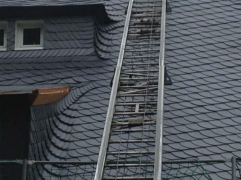 Eine Leiter führt auf das Dach eines Gebäudes