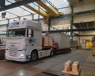 Ein weisser Sattelschlepper in einer Lagerhalle. Foto von der Weiss Transporte AG.