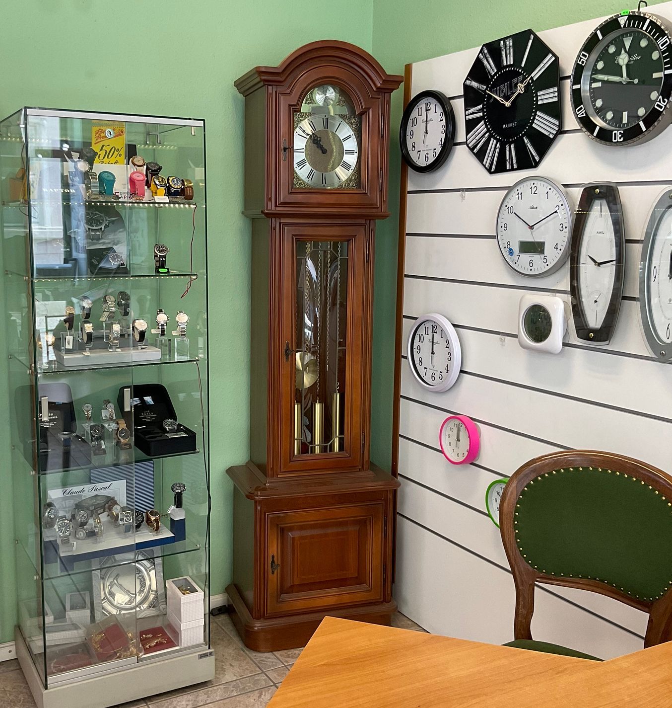 Ein Raum mit Uhren an der Wand und einem Tisch