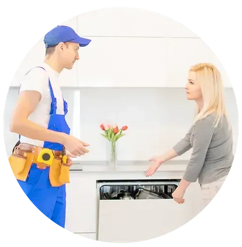 Un hombre está de pie junto a una mujer en una cocina hablando con ella.