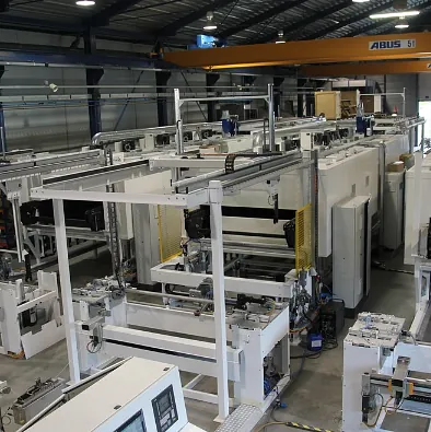 Ein großes Lagerhaus mit vielen Maschinen und einem Kran, auf dem Widder steht