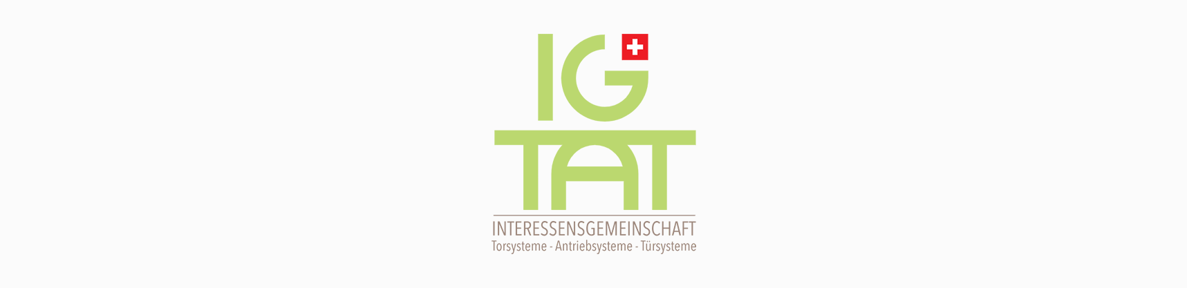 Ein grün-weißes Logo für IG Tat auf weißem Hintergrund