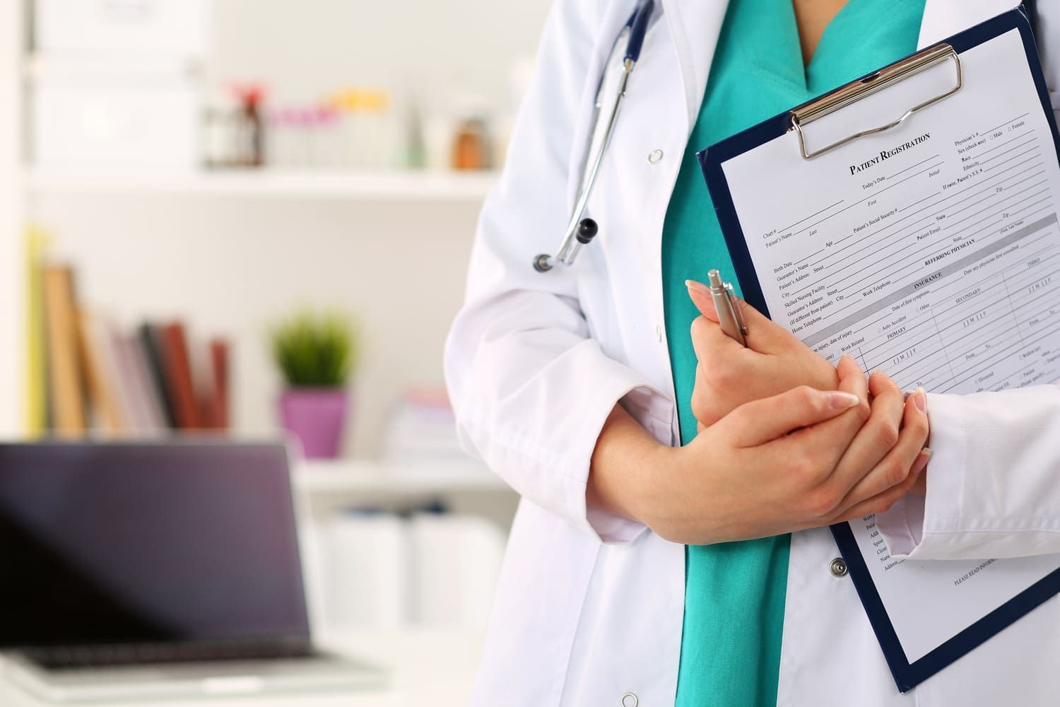 Un médico sostiene un portapapeles en sus manos.