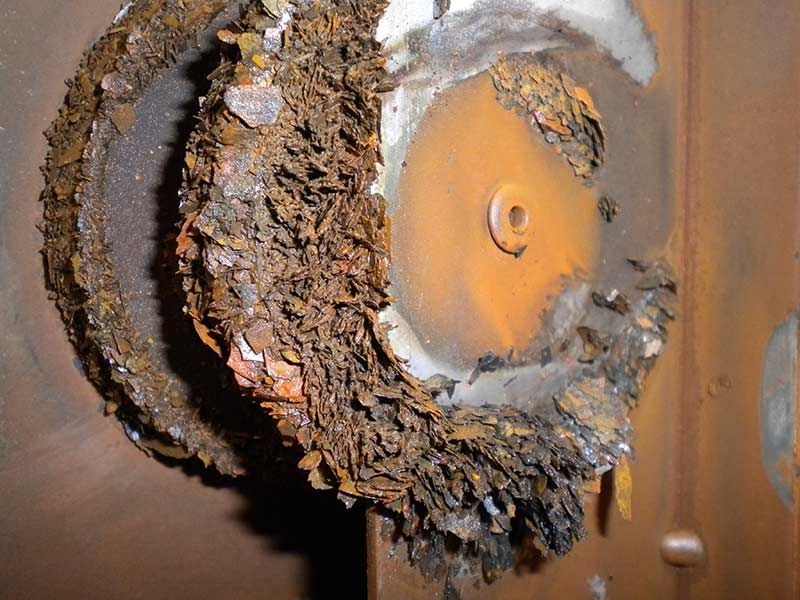 MdA an einer Bestandsanlage, „Ausräumung“ der Anlagenleitungen, hier überwiegen Rostprodukte, die rotbraune Farbe der Leitbleche, weist auf einen hohen Sauerstoffgehalt des Heizungswassers hin.