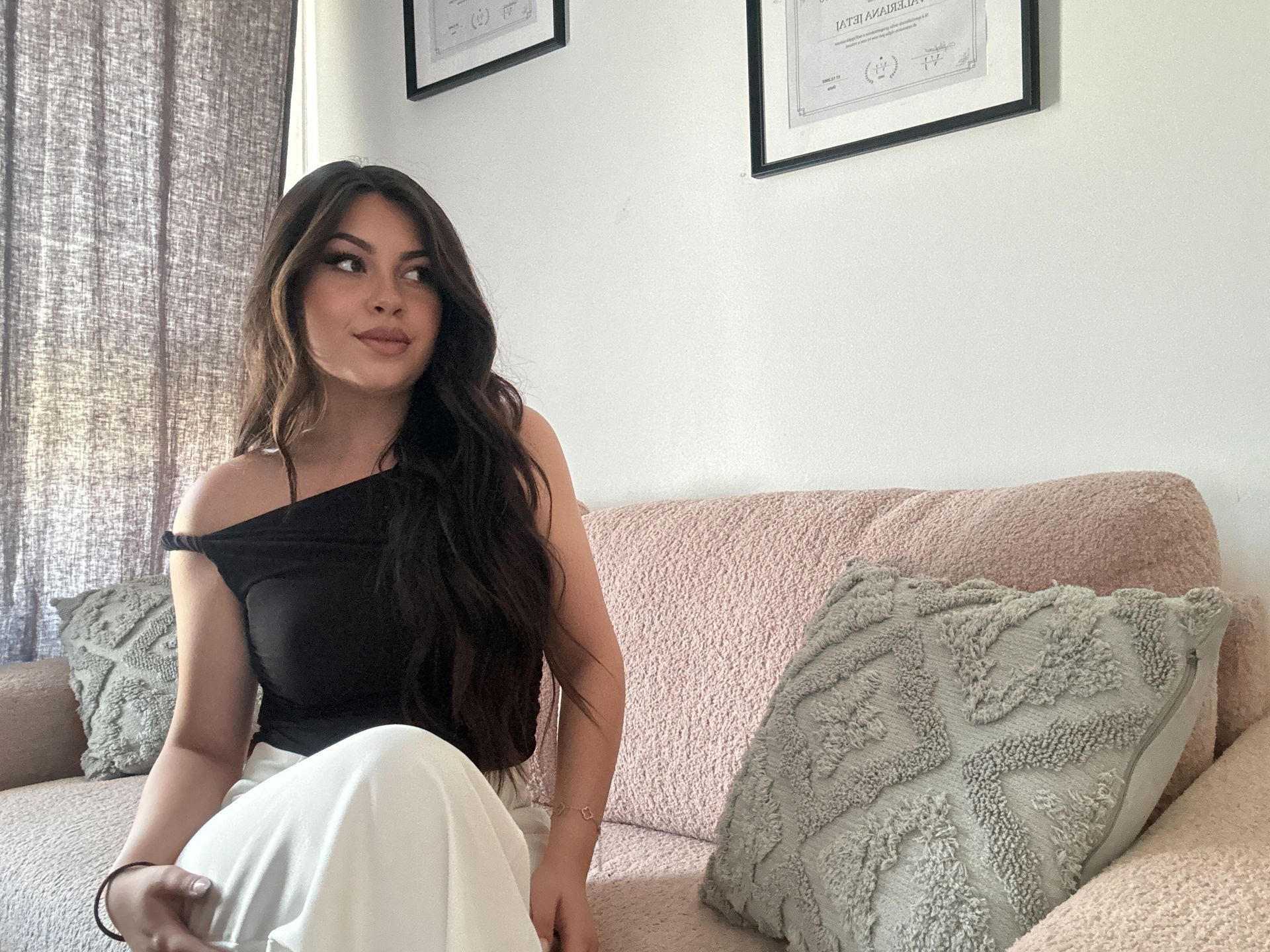 Una donna è in piedi davanti a uno scaffale in un soggiorno.