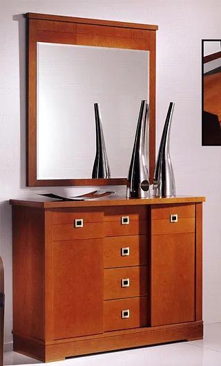 Una cómoda de madera con cajones y un espejo encima.