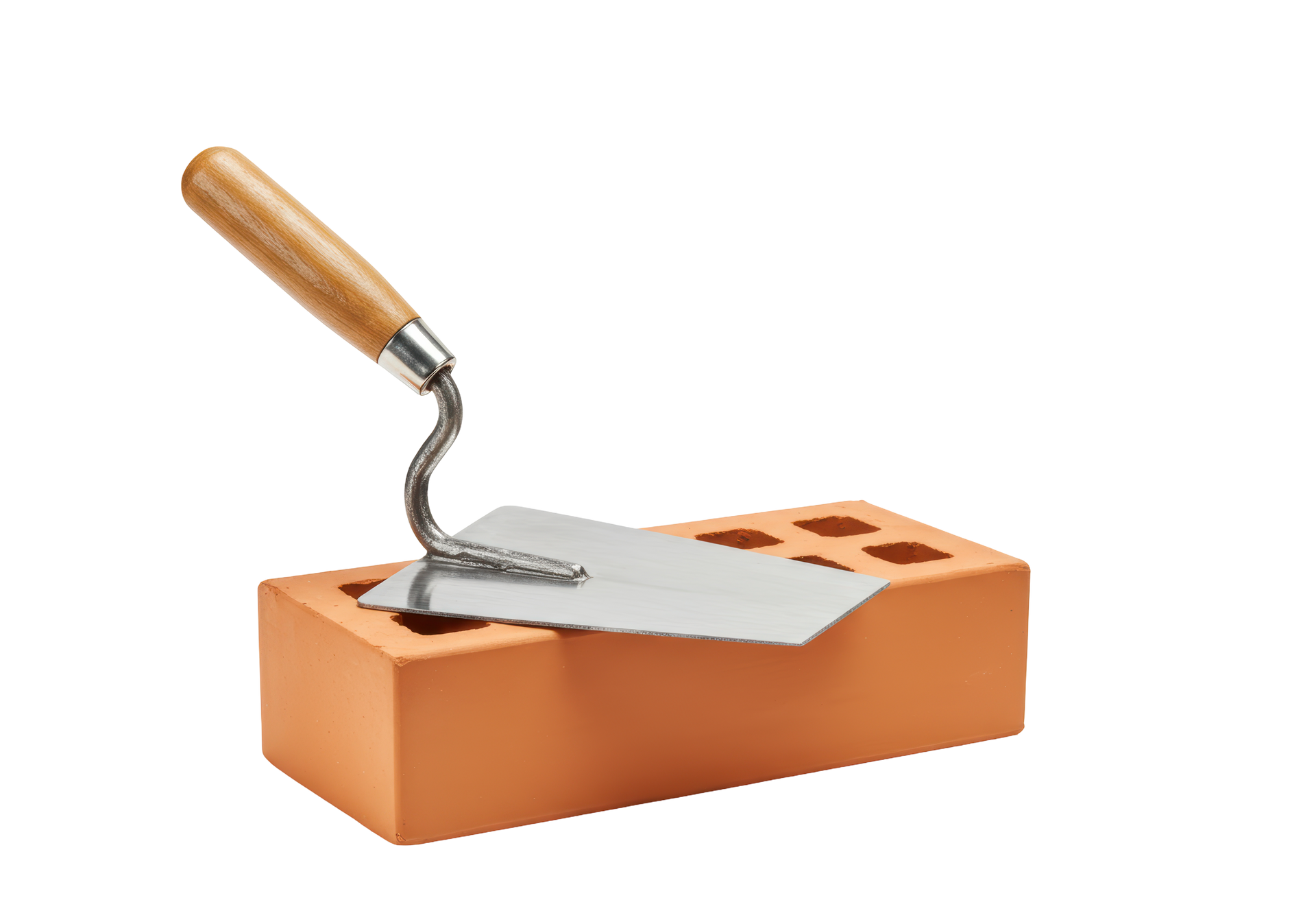 Une truelle posée sur une brique en terre cuite.
