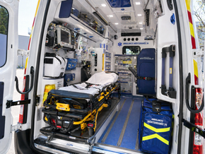 À l'intérieur d'une ambulance, une civière et du matériel médical sont fixés dans le compartiment patient.