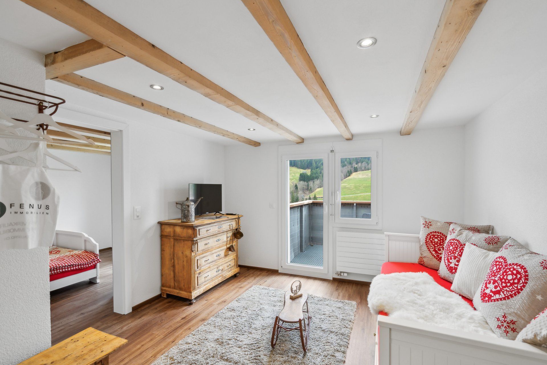A living room with a couch , dresser , and television.