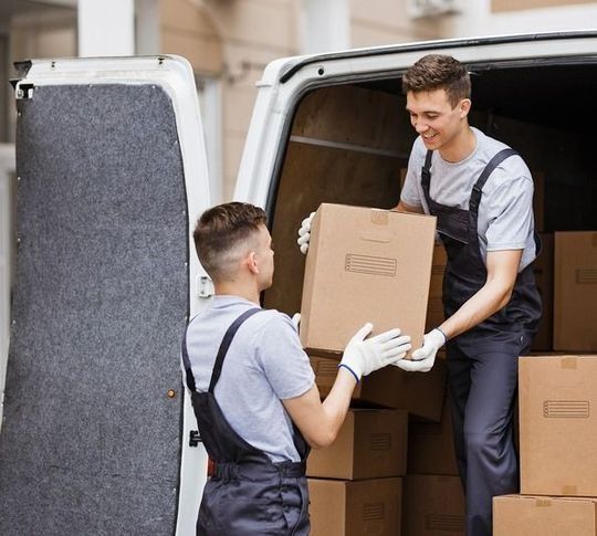 Dos hombres están cargando cajas en una camioneta.