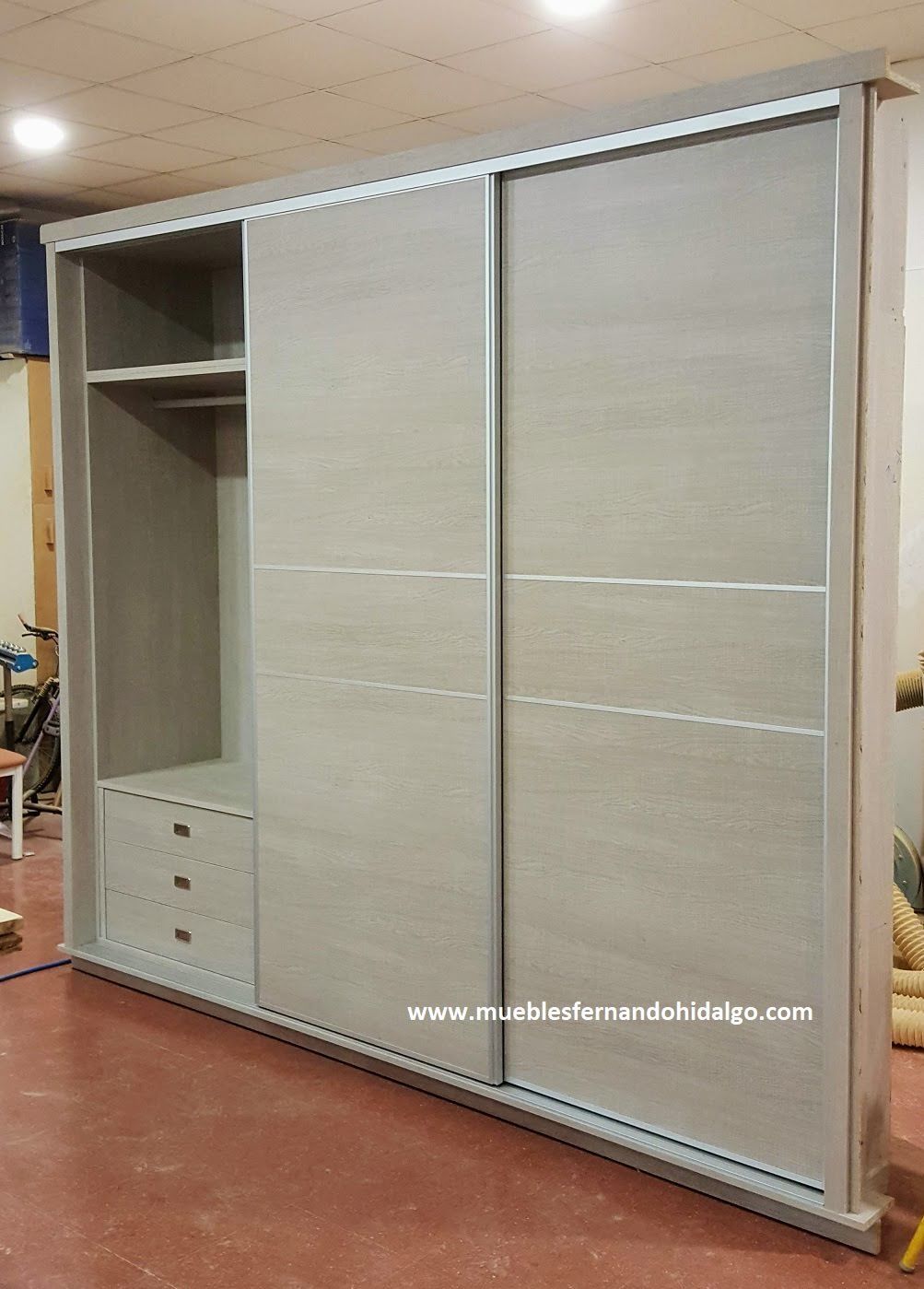 Un gran armario con puertas correderas y cajones en una habitación.