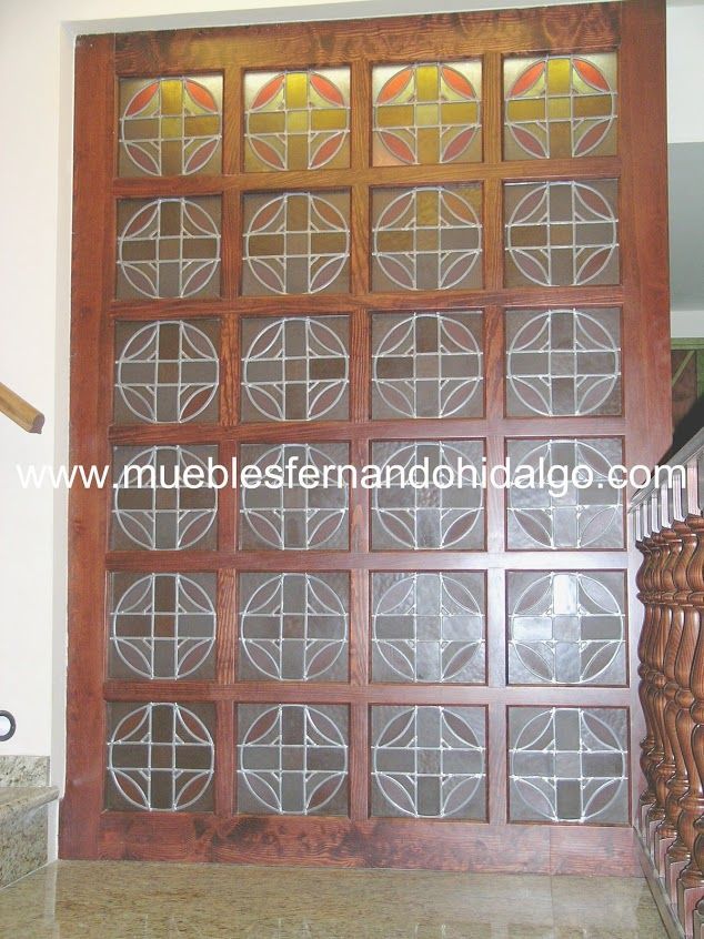 Una puerta de madera con diseño de vidrieras y la página web www.mueblesfernandohidalgo.com