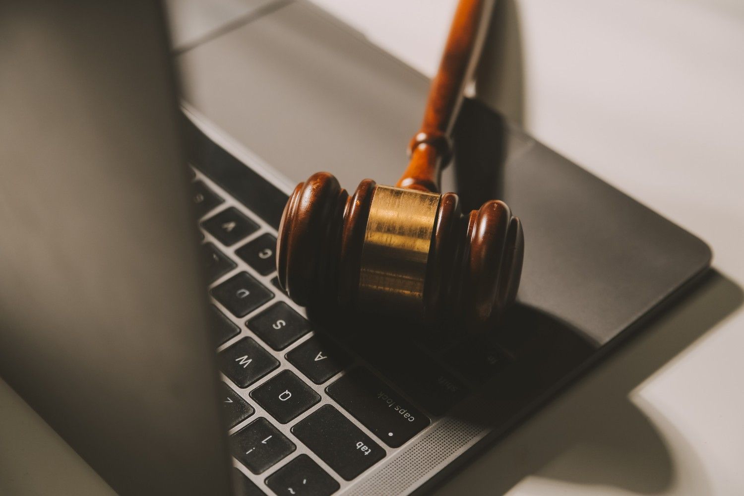 Mazo de madera sobre un teclado de ordenador portátil.