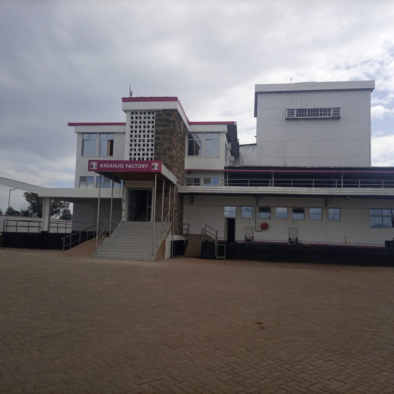 A large white building with a red sign that says general motors