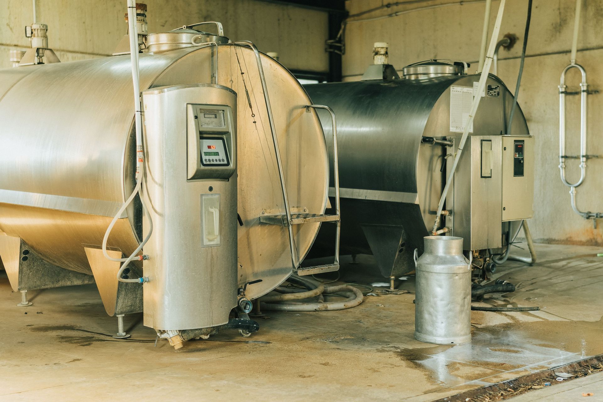 Two stainless steel tanks are sitting in a room