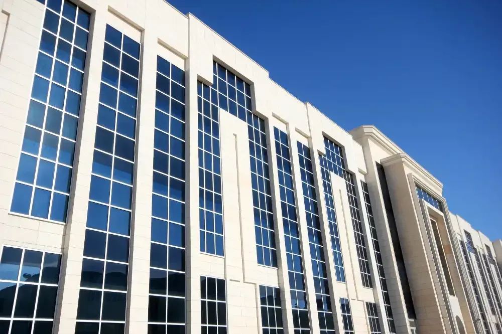 A large building with lots of windows against a blue sky